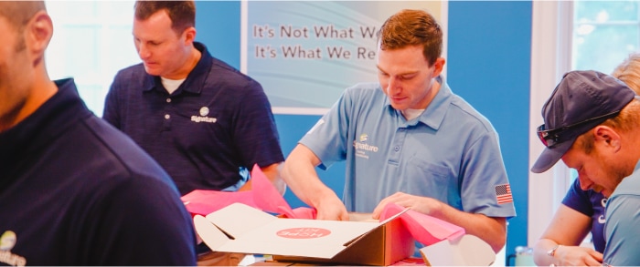 Signature HVAC team members in a training session at the Signature HVAC training room