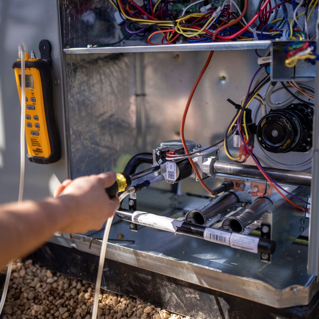 Heat pump being serviced using a screwdriver